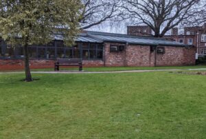 The Watering Can cafe backing onto Marie Curie walled garden