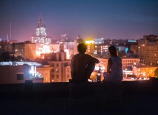 Couple looking into city Photo by Alexander Popov on Unsplash