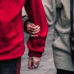 Elderly couple holding hands