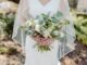 Woman in white wedding dress holding flower bouquet