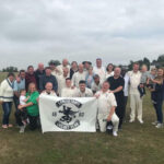 Earlestown Cricket Club holding their banner