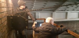 Workers winching up a chandelier