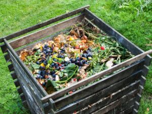 Wooden box with decomposing food inside, compost bin