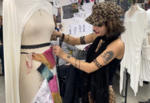 Customer inspecting a fancy dress costume (c) Amelia Hampson