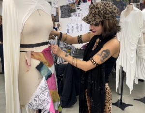 Customer inspecting a fancy dress costume (c) Amelia Hampson