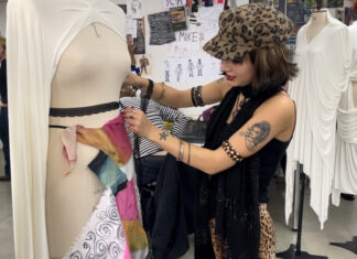 Customer inspecting a fancy dress costume (c) Amelia Hampson