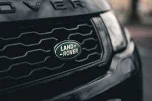 Land Rover badge on the front grill of the car.