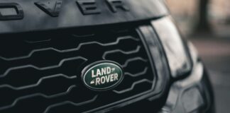 Land Rover badge on the front grill of the car.