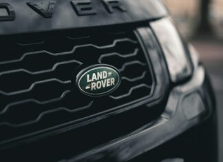 Land Rover badge on the front grill of the car.