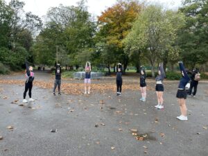 Image of Girls on the Go warming up at the Sunday run club in Sefton Park (c) Megan Wells