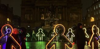 Embrace artwork by Beamhacker, gingerbread figures holding hands as LED lights.