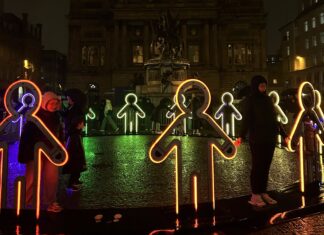 Embrace artwork by Beamhacker, gingerbread figures holding hands as LED lights.