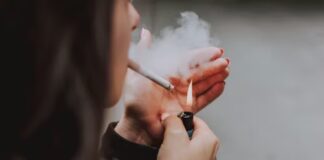 A woman lighting a cigarette