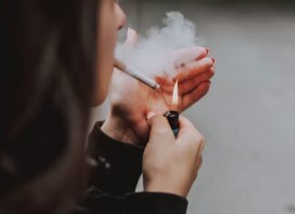 A woman lighting a cigarette