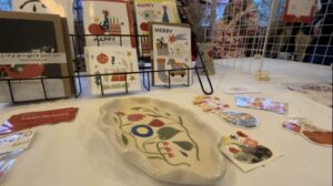 A table at Emmy Porter's stall, showing some locally made ceramics and home made Christmas cards on display.