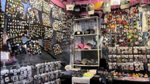 An image of a market stall at the event, showing a wide variety of pins, sew-on patches, caps, T-shirts and other knick-knacks.