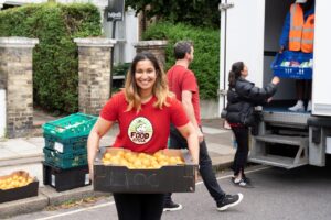 Image of FoodCycle volunteer helping (c) Deb James, FoodCycle