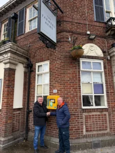 Mark King delivering defibrillator to community centre
