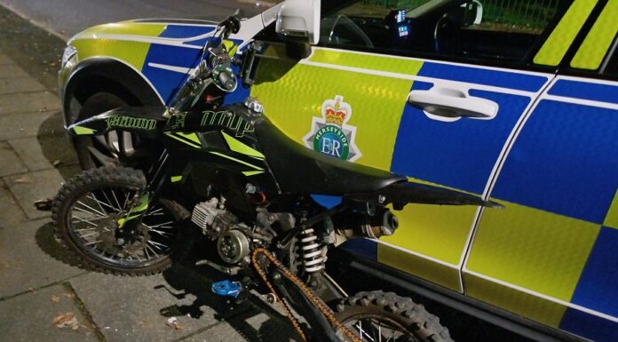 Teen arrested after scrambler bike seizure Scrambler bike leaning up against a police car