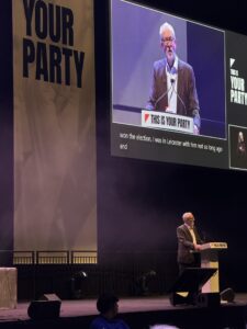 Jeremy Corbyn stood on stage giving a speech