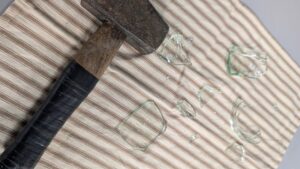 Hammer with broken glass after smashing it at Messy Grief Ceremony