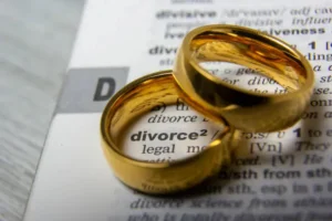 Two wedding rings sat on top of the definition of divorce