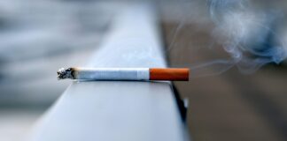 A photo of a cigarette resting on a wall
