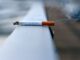 A photo of a cigarette resting on a wall