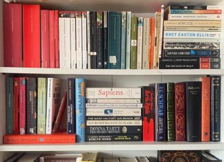 An Image of a range of books on a book shelf.