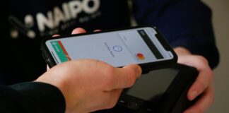 Hand tapping a contactless card machine