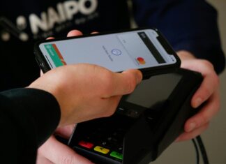 Hand tapping a contactless card machine