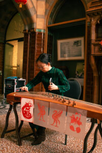 Woman playing guzheng.