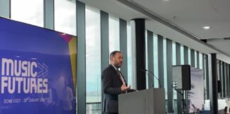 Ian Murray MP speaking on stage, to the right of the MusicFutures logo