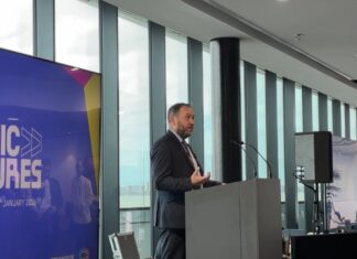 Ian Murray MP speaking on stage, to the right of the MusicFutures logo