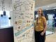 Dr Katherine Neary, Senior Lecturer in International Business, stood in front of a research poster