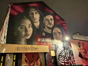 Mural of rock band The Mysterines on the side of Rockpoint Records.