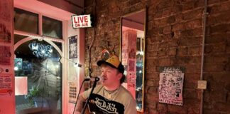 Musician Paddy Turner performing with a guitar at Rockpoint Records