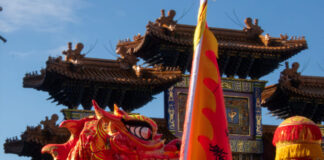 Chinese dragon dance in front of the Chinatown arch.