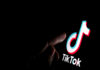 Stone / UK - July 28 2019: TikTok app logo on the screen and a finger about to touch it. - adobe stock image