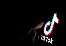 Why TikTok is driving UK waiting lists to 2026 record highs Stone / UK - July 28 2019: TikTok app logo on the screen and a finger about to touch it. - adobe stock image