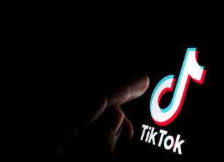 Stone / UK - July 28 2019: TikTok app logo on the screen and a finger about to touch it. - adobe stock image