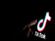 Stone / UK - July 28 2019: TikTok app logo on the screen and a finger about to touch it. - adobe stock image