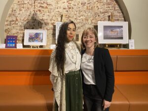 artist and curator standing together