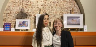 artist and curator standing together