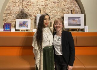 artist and curator standing together