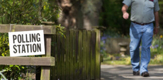 A person leaves a polling station, near St Luke's Church, in Formby