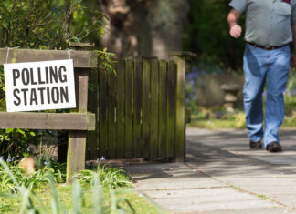 A person leaves a polling station, near St Luke's Church, in Formby