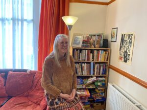 Mandy Vere by bookshelf at home