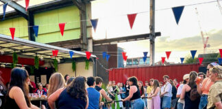 People playing tug of war at a previous Lavender Nights event