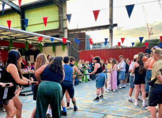 People playing tug of war at a previous Lavender Nights event